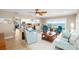 Spacious living room with comfortable seating, wood floors, ceiling fan, and water views at 9048 Wharf Ave, Placida, FL 33946