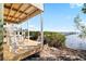 Relaxing outdoor seating area overlooks tranquil water, complemented by a charming dock at 9048 Wharf Ave, Placida, FL 33946