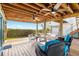 Outdoor seating area with ceiling fans, views of the bay, string lights, and wooden deck at 9048 Wharf Ave, Placida, FL 33946