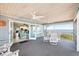 Relax on the screened patio with waterfront views, dining area, and ceiling fans for comfortable outdoor living at 9048 Wharf Ave, Placida, FL 33946