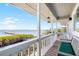 Outdoor patio with railing and seating overlooking the water and mangroves at 9048 Wharf Ave, Placida, FL 33946