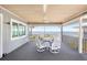 Covered patio features waterfront views, a dining area, ceiling fan, and comfortable outdoor seating for entertaining at 9048 Wharf Ave, Placida, FL 33946