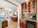 Entertaining wet bar with wine fridge, sink, and glassware storage in the cabinets at 9048 Wharf Ave, Placida, FL 33946