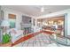 Bright living room with fireplace, hardwood floors, and an open layout to the dining area at 938 16Th N Ave, St Petersburg, FL 33704