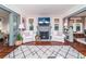 Cozy living room with hardwood floors, a brick fireplace, and neutral-colored furniture at 938 16Th N Ave, St Petersburg, FL 33704