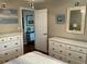 Bedroom featuring two dressers and a view of a living area through a door at 10032 65Th N Ave # 14, St Petersburg, FL 33708