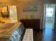 Bedroom featuring a bed with decorative pillows and a view of a bathroom and living area at 10032 65Th N Ave # 14, St Petersburg, FL 33708