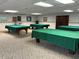 Spacious game room featuring multiple pool tables covered in green felt at 10032 65Th N Ave # 14, St Petersburg, FL 33708