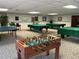 Bright game room equipped with a foosball table, ping pong, and pool tables at 10032 65Th N Ave # 14, St Petersburg, FL 33708