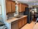 Stylish kitchen featuring wooden cabinets, stainless appliances, and a tiled backsplash for a touch of elegance at 10032 65Th N Ave # 14, St Petersburg, FL 33708