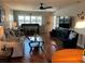 Bright living room featuring hardwood floors, a cozy sofa, and a view of the dining area creating a welcoming atmosphere at 10032 65Th N Ave # 14, St Petersburg, FL 33708