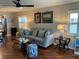Cozy living room with hardwood floors, a comfortable sectional sofa, and natural light creating a welcoming atmosphere at 10032 65Th N Ave # 14, St Petersburg, FL 33708