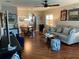 Comfortable living room featuring hardwood floors, a stylish sofa, and views of the dining area creating an inviting space at 10032 65Th N Ave # 14, St Petersburg, FL 33708