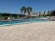 Inviting outdoor pool with ample seating and a relaxing atmosphere overlooking the water at 10032 65Th N Ave # 14, St Petersburg, FL 33708