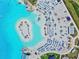 Aerial view of lagoon with sandy beach, chairs, umbrellas, and fun water park at 11146 Rustic Timber Loop, San Antonio, FL 33576