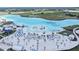 Aerial view of a large lagoon-style community pool with sandy beach and aqua park at 11146 Rustic Timber Loop, San Antonio, FL 33576