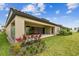 Backyard featuring a covered patio, landscaped garden, and well-maintained lawn at 11146 Rustic Timber Loop, San Antonio, FL 33576