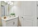 A vanity with a white countertop complements the bathroom, enhanced by a vase of greenery at 11146 Rustic Timber Loop, San Antonio, FL 33576
