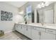 A bathroom featuring double vanity, modern fixtures, and decorative artwork at 11146 Rustic Timber Loop, San Antonio, FL 33576