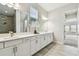 Bright bathroom featuring double vanity, modern fixtures, and neutral color palette at 11146 Rustic Timber Loop, San Antonio, FL 33576