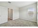 This bedroom includes neutral carpet, baseboard trim, and a doorway for access to other rooms at 11146 Rustic Timber Loop, San Antonio, FL 33576