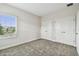Bedroom features neutral carpet, and a large window for natural light at 11146 Rustic Timber Loop, San Antonio, FL 33576