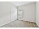Carpeted bedroom features a double-door closet and a window at 11146 Rustic Timber Loop, San Antonio, FL 33576