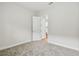 Bright, neutral bedroom offers soft gray carpeting, white trim and doors, and views of the stairs at 11146 Rustic Timber Loop, San Antonio, FL 33576