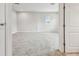 Bedroom featuring neutral carpet, a window with blinds and white trim and a white paneled door at 11146 Rustic Timber Loop, San Antonio, FL 33576