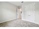 Carpeted bedroom featuring a double-door closet and neutral wall color at 11146 Rustic Timber Loop, San Antonio, FL 33576