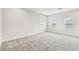 Large, carpeted bonus room illuminated by natural light from three windows with neutral trim at 11146 Rustic Timber Loop, San Antonio, FL 33576