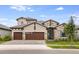 Stunning two-story home featuring a stone facade, three-car garage, and manicured front lawn at 11146 Rustic Timber Loop, San Antonio, FL 33576