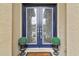 Elegant double front doors with decorative glass insets, potted plants, and a welcoming doormat at 11146 Rustic Timber Loop, San Antonio, FL 33576