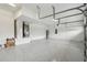 Spacious garage featuring a clean, epoxy floor, ample lighting, and plenty of room for parking and storage at 11146 Rustic Timber Loop, San Antonio, FL 33576