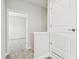 Neutral hallway with carpeted floor and a view into a room, along with a white closet door at 11146 Rustic Timber Loop, San Antonio, FL 33576