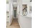 A bright hallway featuring light wood flooring, white walls and molding, plus sight lines to multiple rooms at 11146 Rustic Timber Loop, San Antonio, FL 33576