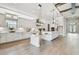 Bright, spacious kitchen with white cabinets, a large island, and modern lighting fixtures at 11146 Rustic Timber Loop, San Antonio, FL 33576