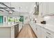 Modern kitchen with stainless steel appliances, white cabinets, and a large island overlooking the backyard at 11146 Rustic Timber Loop, San Antonio, FL 33576