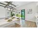 Open concept kitchen with white cabinets, stainless steel appliances, a large island, and a view to the backyard at 11146 Rustic Timber Loop, San Antonio, FL 33576