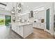 Modern kitchen with a central island, white cabinets, subway tile backsplash and pendant lighting at 11146 Rustic Timber Loop, San Antonio, FL 33576
