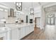 Well-equipped kitchen featuring a large island with marble countertops, modern appliances and white cabinetry at 11146 Rustic Timber Loop, San Antonio, FL 33576