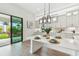 Well-lit kitchen with a large island and breakfast bar, white cabinets, stainless appliances, and a sliding glass door to the backyard at 11146 Rustic Timber Loop, San Antonio, FL 33576