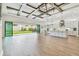 Spacious living room featuring an open floor plan, backyard access, modern lighting, and a kitchen with a large island at 11146 Rustic Timber Loop, San Antonio, FL 33576