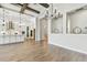Spacious living room with hardwood floors, light walls, and view to a well-equipped kitchen and dining area at 11146 Rustic Timber Loop, San Antonio, FL 33576
