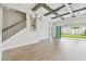 Spacious living room features staircase, wood-look tile floors and disappearing sliding glass doors to backyard at 11146 Rustic Timber Loop, San Antonio, FL 33576