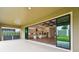 A spacious patio transitions to an open-concept interior with a view of the backyard at 11146 Rustic Timber Loop, San Antonio, FL 33576