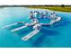 Inflatable water obstacle course in the community lagoon, providing a fun activity at 11146 Rustic Timber Loop, San Antonio, FL 33576