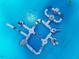 An aerial view of a blue lagoon and floating obstacle water course at 11146 Rustic Timber Loop, San Antonio, FL 33576