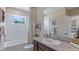 Bathroom with granite countertop, white tiled shower, and neutral tones creating a serene space at 11404 Velvet Apricot Dr, Land O Lakes, FL 34638