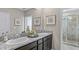 Elegant bathroom features double sinks, granite countertops, and a walk-in shower at 11404 Velvet Apricot Dr, Land O Lakes, FL 34638